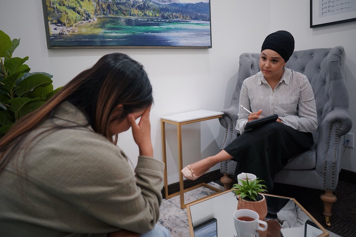 A counsellor listening to a client during a session